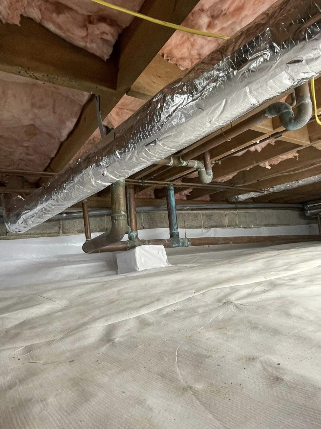 Crawlspace in home with old pipes